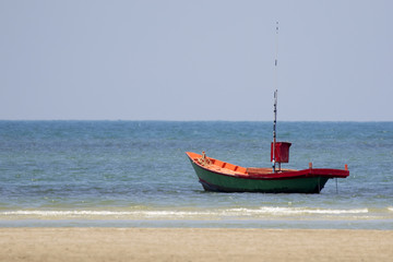 Image of small boat sitting on the beach.