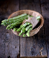 Fresh green asparagus on an old wooden background. Healthy food.