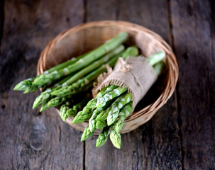 Fresh green asparagus on an old wooden background. Healthy food.