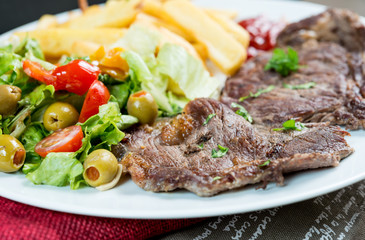 juicy steak beef meat with tomato and french fries
