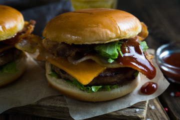Hamburgers and beer on a wooden table