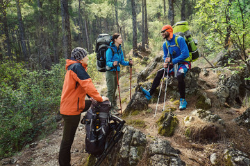 Friends tourists hiking at the mountain forest. Real people traveling with backpacks and all equipment on Lycian Way in Turkey.