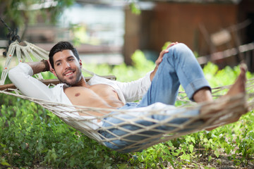 young sexy man in a hammock,shallow depth of field