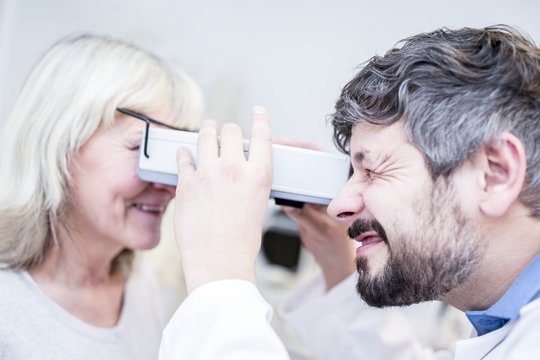 Optometrist performing eye test