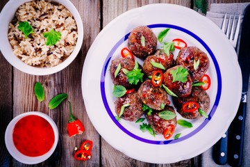 homemade meatballs with wild rice, mint, green onions and chili sauce