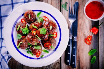 homemade meatballs with mint, green onions and chili sauce
