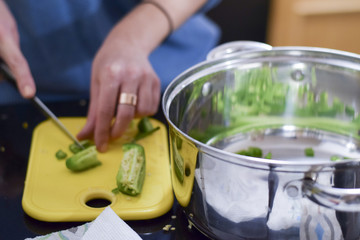 Woman chopping jalapeno peppers