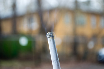 Ashes and smoke from a cigarette.