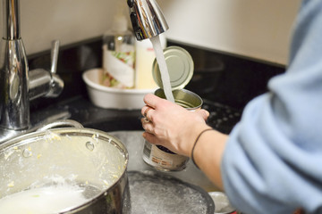 Closeup on woman's hands washing dirty dishes
