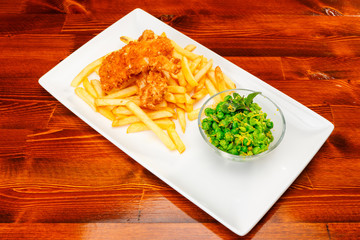 Chicken nuggets with fries and a salad