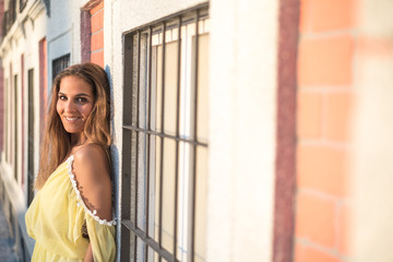 Fototapeta premium young pretty woman smiling isolated close up outdoor with a yellow dress