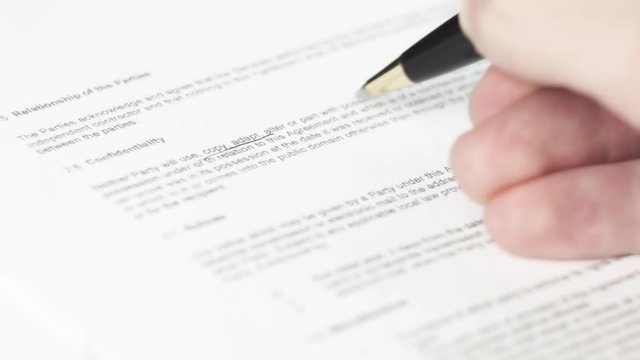 Underlying and highlight word with pen in business documents (NDA, agreement, contract, appointments, mortate, papers)