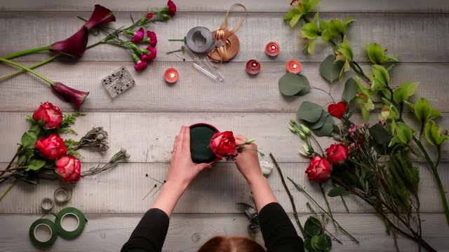 Video of creating a bouquet of roses. View from above, cinemagraf, beautiful flowers, video acceleration