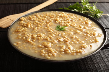 Homemade  healthy Wheat porridge served in wooden table 