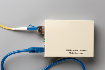 1Gbps optical media converter with SFP module connected to fiber patch cord and copper patch cord