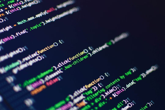 Software development. Software source code. Programming code. Writing programming code on laptop.