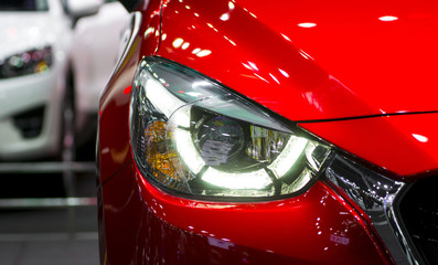 Headlights and hood of sport red car with silver stars