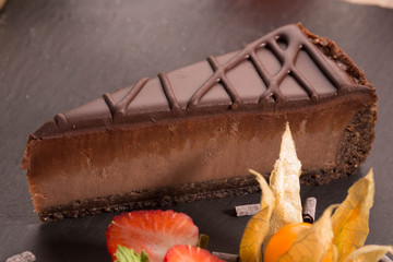 Cheesecake chocolate with a sand layer, cream cheese and icing sugar