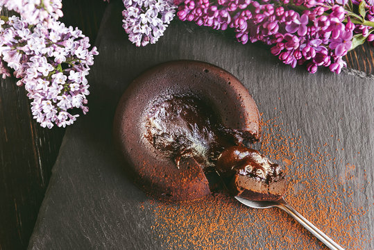Classic chocolate fondant on a dark background with flowers