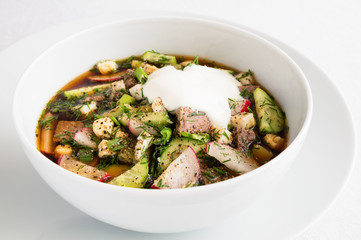 a bowl of okroshka with sour cream