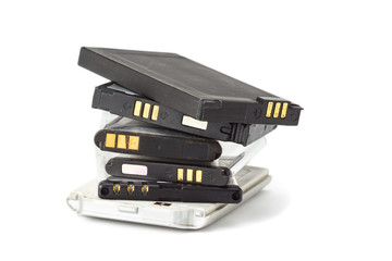 pile of old and expired rechargeable battery for cell phone on white background