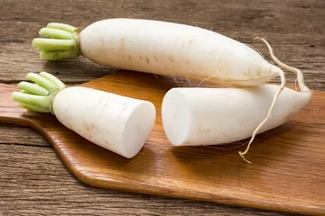 Fotobehang freshness and ripe chinese radish on wooden chopping block © reshoot