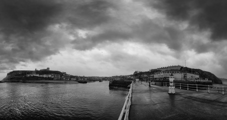 whitby in stormy weather with waterfront pier and river 