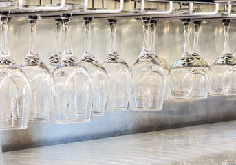 Wine Glasses Hanging Over Metal Counter: Wine glasses hanging upside down at a restaurant in Montgomery, Alabama. 
