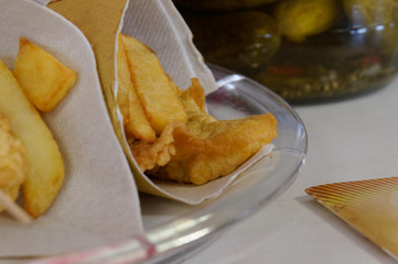 Shrimps, potatoes and vegetables in batter, fried . Street food in cardboard package.