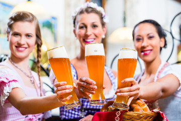 Group of people with wheat beer in Bavarian pub