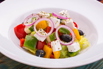 Salad Greek with fresh vegetables, seasoned with olive oil with lemon juice
