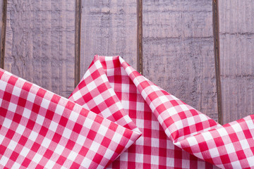 Red table cloth on wooden background
