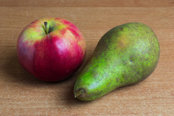 Apple and pear on the table.