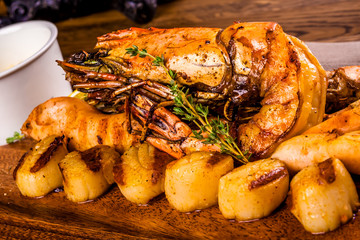 Grilled seafood with spices on wooden board