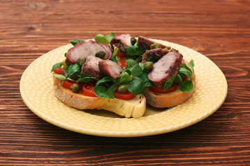 Open sandwich with pork greens and capers