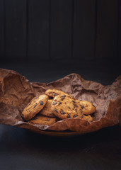 Chocolate chip cookies over dark background