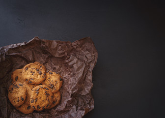 Chocolate chip cookies over dark background