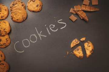 Chocolate chip cookies over dark background