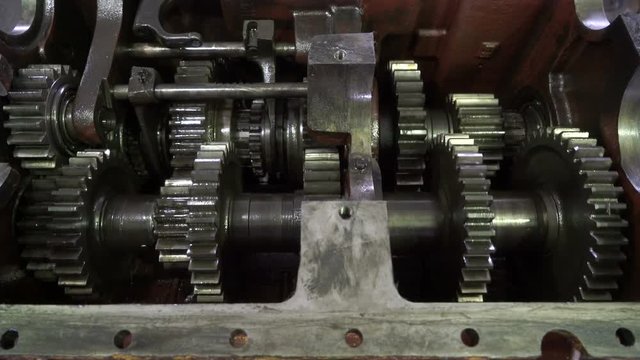 Open gearbox. Gears rotate. Transmission check and repair.Transmission gears closeup detail.