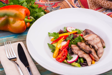 Mutton uvulas with salad and paprika, is served in dressing from olive oil