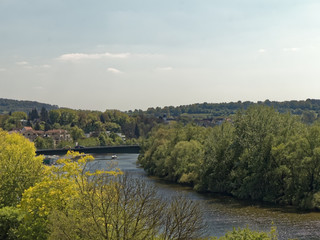 Fototapeta na wymiar River bend with old town and bridge in the background