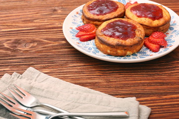 Cottage cheese patties with strawberry jam.