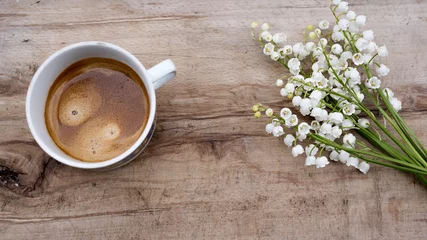 Tragetasche Background bouquet of lily of the valley, a cup of espresso coffee on old wooden top. © Hristina