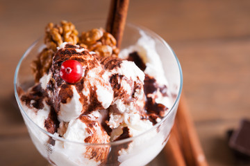 Ice cream sundae with cranberry, spices and walnuts 