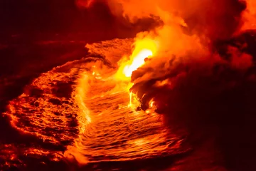 Poster Im Rahmen Lava flow pouring into Hawaii ocean at night. Lava falling in ocean waves in Hawaii from Hawaiian Kilauea volcano at night. Molten lava washed by the pacific ocean water crashing in, Big Island, USA. © Maridav