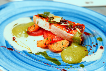 Chicken fillet on blue porcelain plate, toned image
