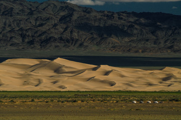 mongolian landscape with horses and yurts