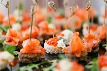 the buffet at the reception. Assortment of canapes. Banquet service. catering food, snacks with...