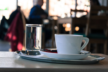 Coffee cup with a glass of water