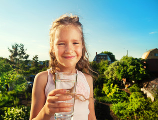 Child holding glass water